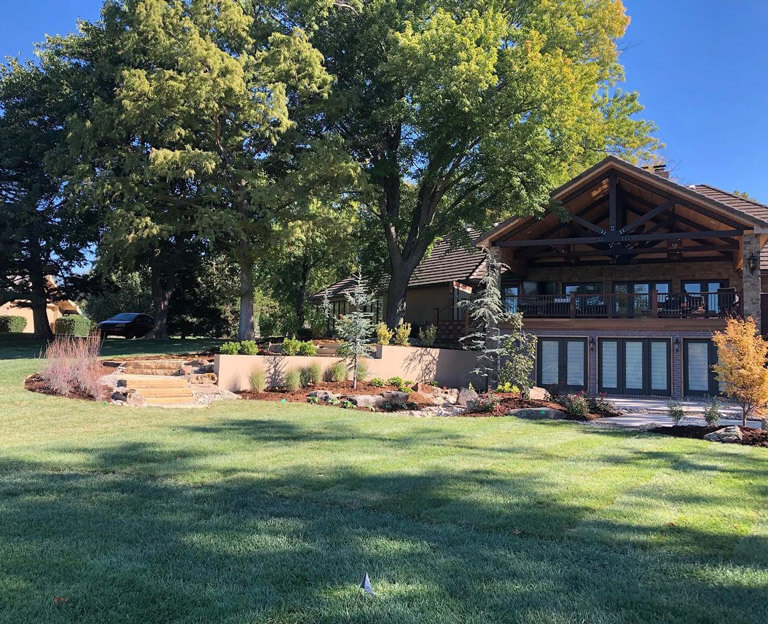 A rustic home with a large, manicured lawn.