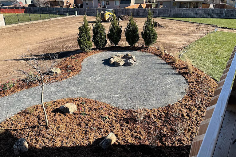 A patio with a natural stone fire pit ring.