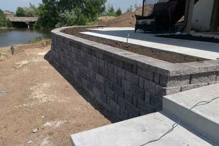 A stone retaining wall with built-in planter.