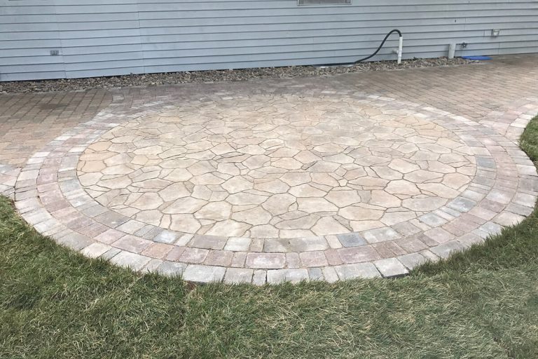 A round stone patio with border design.