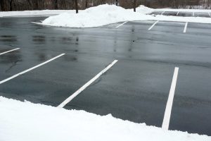 A parking lot that has been cleared of snow.