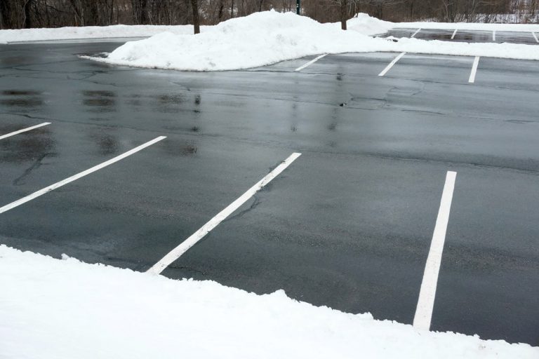 A parking lot that has been cleared of snow.